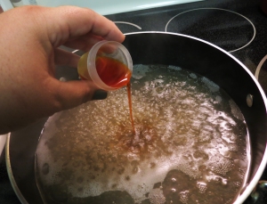 Adding saffron to the boiling broth.