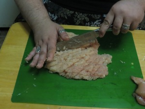 Chopping the meat finely.