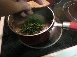 Adding the parsley to the sauce.